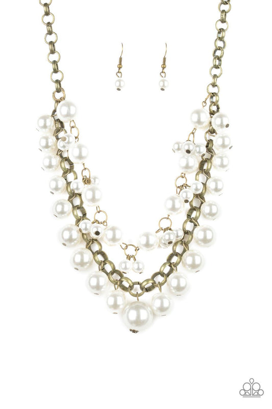 Paparazzi Accessories BALLROOM Service - Brass Two rows of mismatched white pearls gorgeously drape below the collar. Featuring oversized brass links and an assortment of pearl sizes, the bubbly strands layer into a dramatic fringe for a modern timelessne