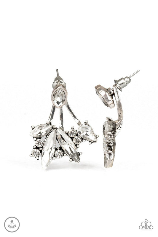 Paparazzi Accessories Deco Dynamite - White A solitaire white marquise cut rhinestone attaches to a double-sided post, designed to fasten behind the ear. Encrusted in a collision of mismatched white rhinestones, a double-sided post peeks out beneath the e
