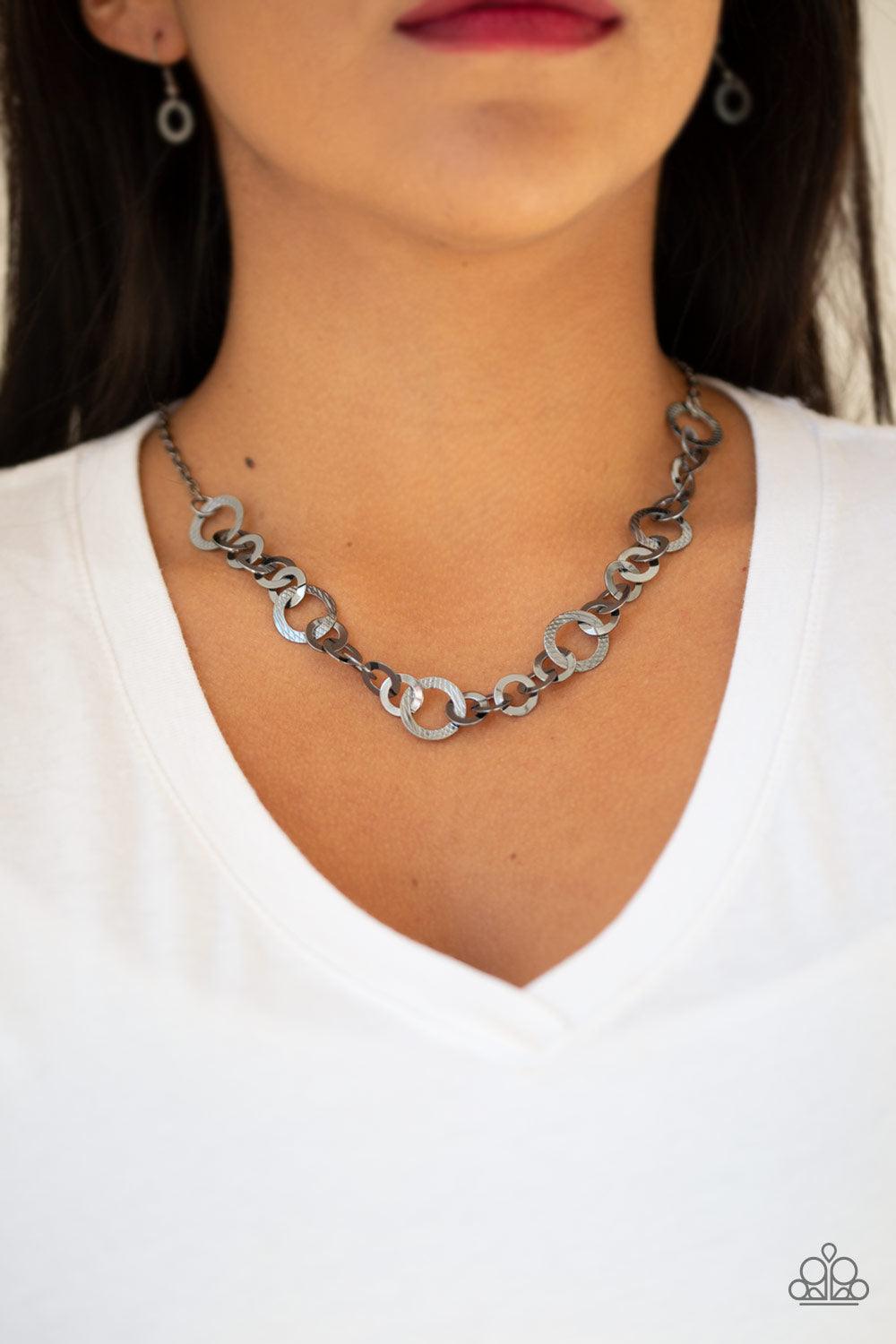 Paparazzi Accessories Move It On Over - Black Smooth and textured gunmetal hoops connect below the collar for a modern industrial look. Features an adjustable clasp closure. Sold as one individual necklace. Includes one pair of matching earrings. Get The