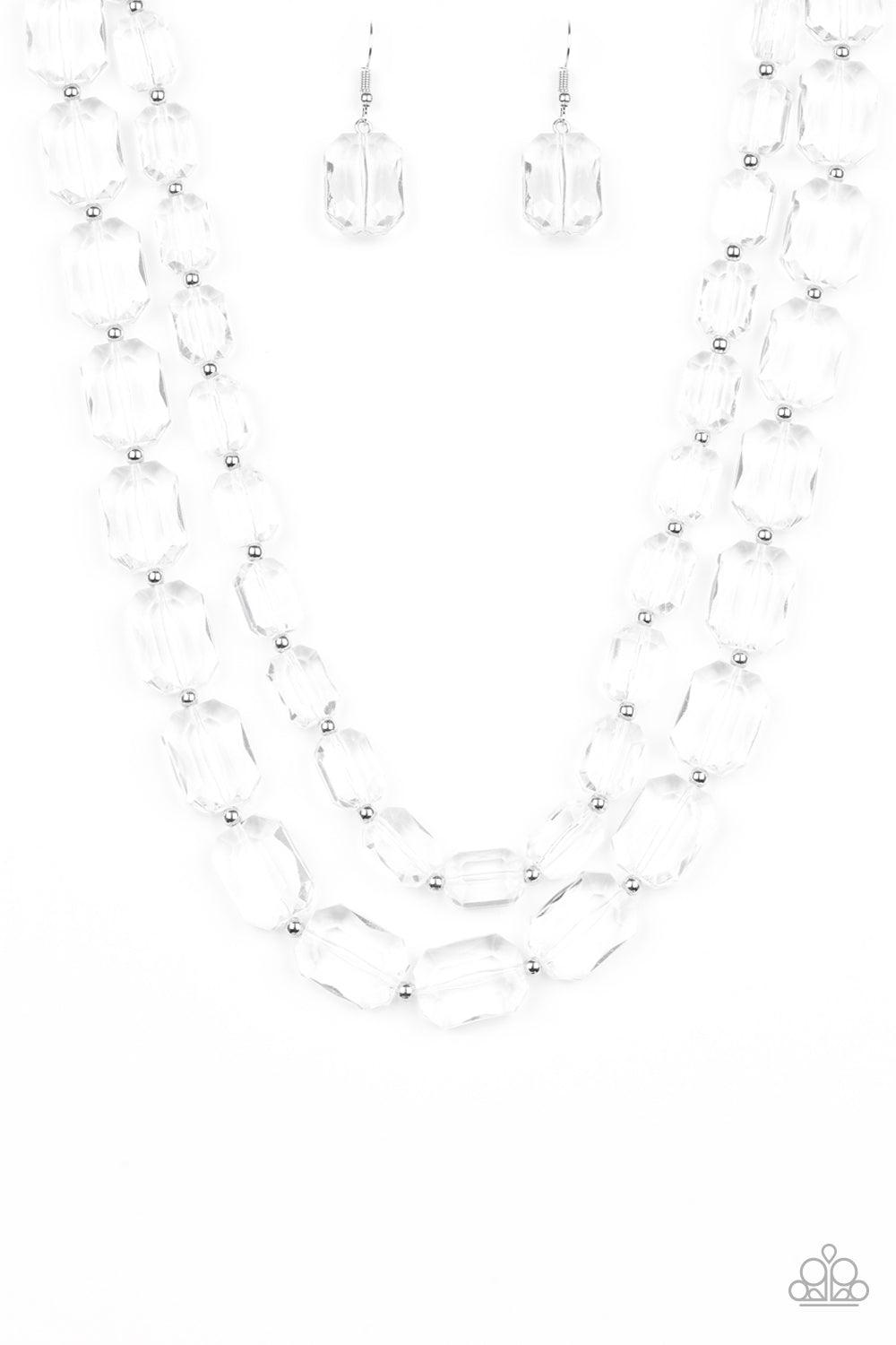 Paparazzi Accessories Ice Bank - White Infused with dainty silver beads, glassy white emerald-cut beads layer below the collar for an edgy look. Features an adjustable clasp closure. Sold as one individual necklace. Includes one pair of matching earrings.