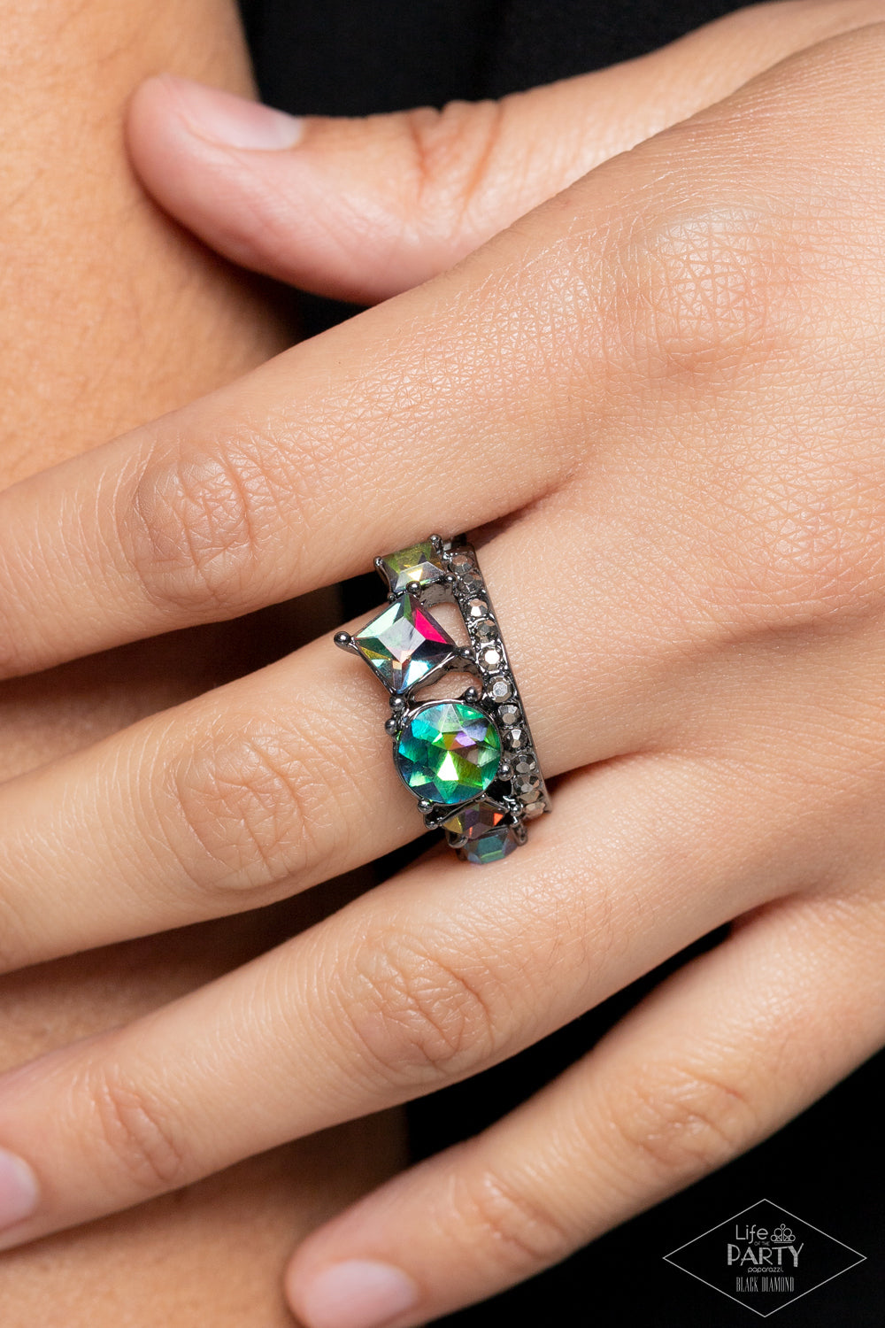 Paparazzi Accessories Champion Couture - Multi Featuring an oil spill finish, a collection of round and square iridescent rhinestones coalesces atop a gunmetal band encrusted in dainty hematite rhinestones for a dramatic look. Features a dainty stretchy b