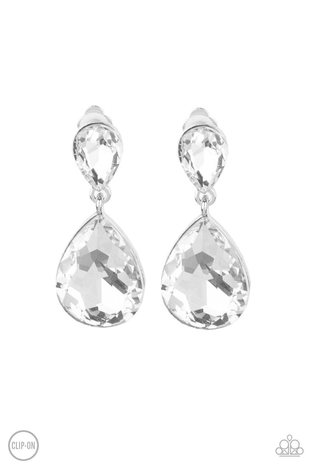 Paparazzi Accessories Aim For The MEGASTARS - White *Clip-On A dramatically oversized white rhinestone teardrop swings from the bottom of a smaller rhinestone teardrop, linking into a glamorous lure. Earring attaches to a standard clip-on fitting. Sold as