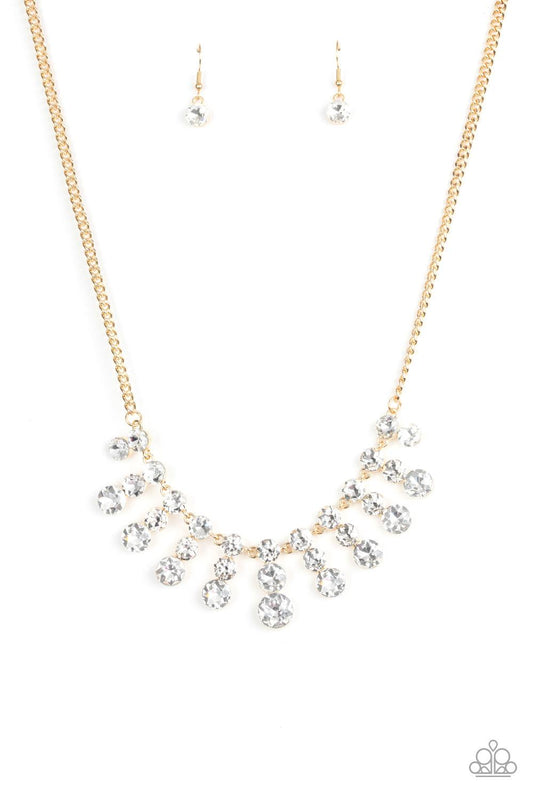 Paparazzi Accessories Celebrity Couture - Gold Glittery stacks of glassy white rhinestones gradually increase in size as they drip from the bottom of a classic gold chain, creating a blinding fringe below the collar. Features an adjustable clasp closure.