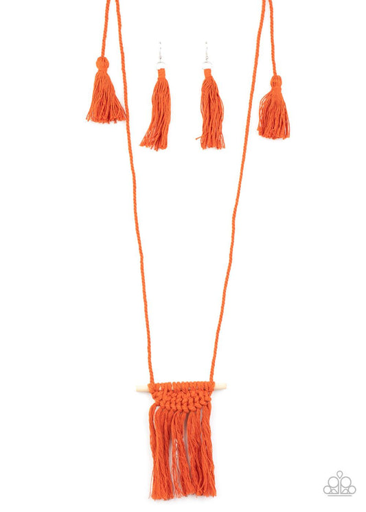 Paparazzi Accessories Between You and MACRAME - Orange Orange cording delicately wraps around a dainty wooden dowel, knotting into a tasseled macrame centerpiece at the bottom of a dramatically lengthened display. Features an adjustable sliding knot closu