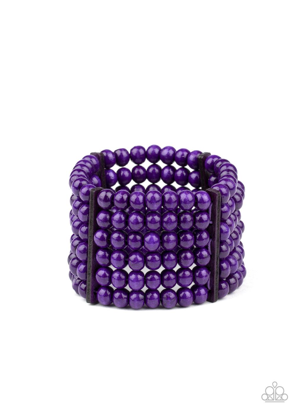 Paparazzi Accessories Diving in Maldives - Purple Held in place with rectangular wooden fittings, a collection of vivacious purple wooden beads are threaded along stretchy bands around the wrist, creating colorful layers. Sold as one individual bracelet.