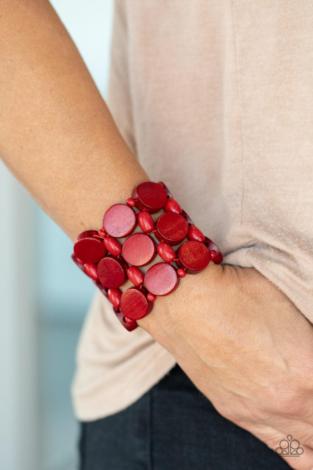Paparazzi Accessories Cruising Coronado - Red Featuring disc, oval, and rounded shapes, a mismatched collection of fiery red wooden beads are threaded along knotted stretchy strands, creating a tropical inspired look around the wrist. Sold as one individu