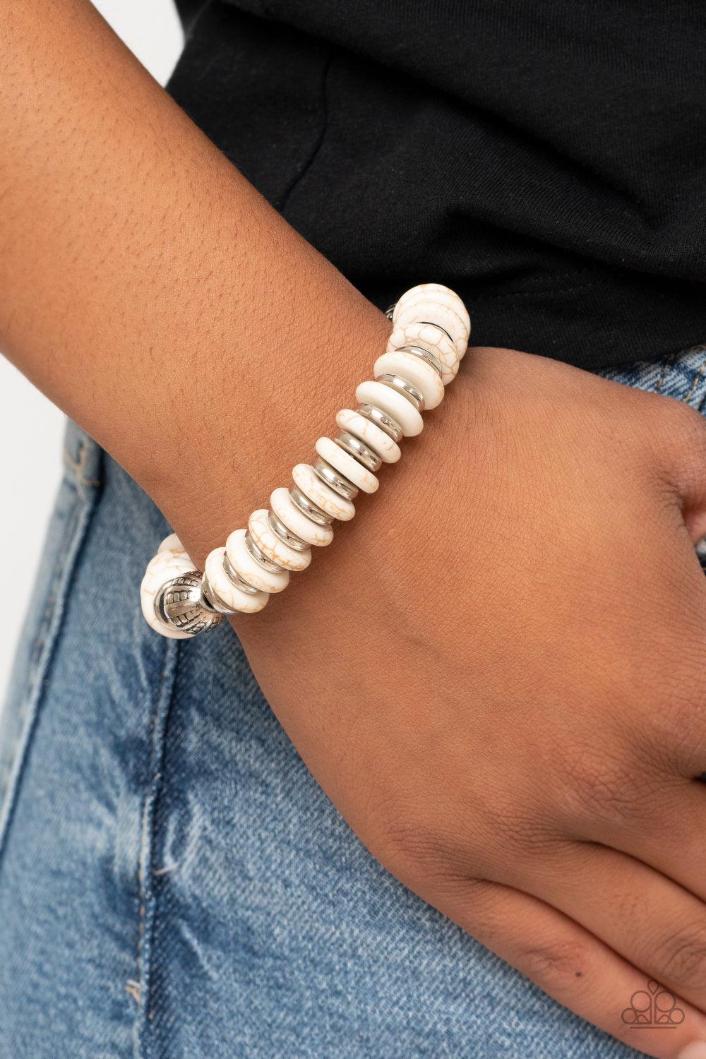 Paparazzi Accessories Eco Experience - White Infused with a pair of ornate silver beads, an earthy collection of shiny silver and refreshing white stone discs alternate along a stretchy band around the wrist for an authentically artisan inspired look. Sol