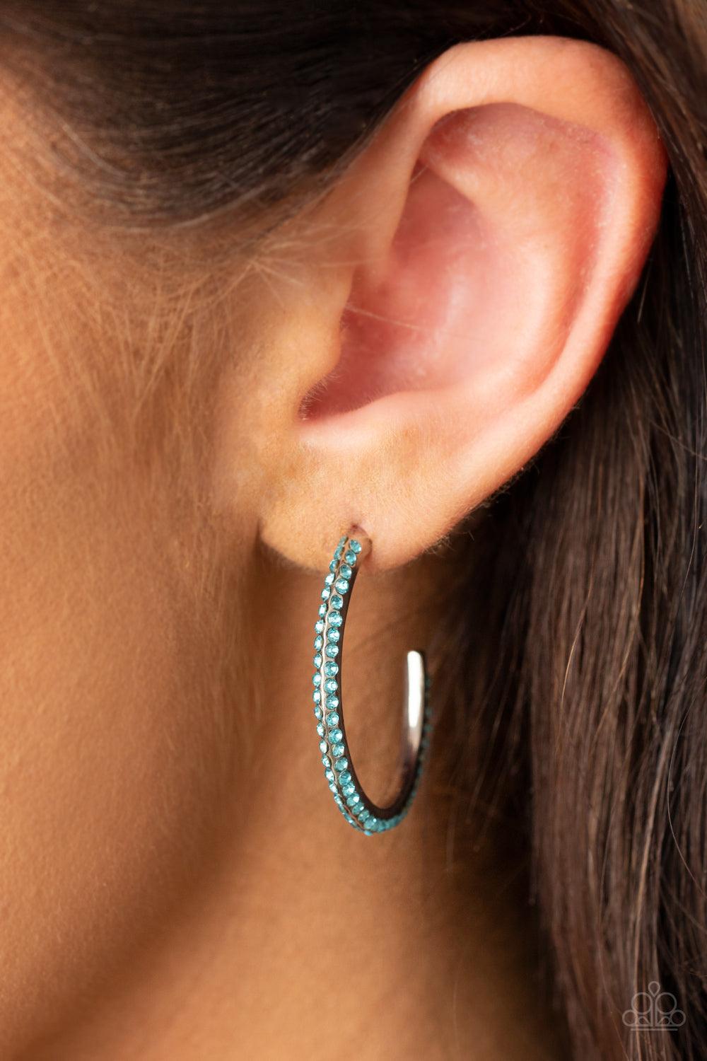 Paparazzi Accessories Dont Think Twice - Blue Two rows of glittery blue rhinestones are encrusted along the edge of a hook shaped silver hoop, creating a glamorously dainty display. Earring attaches to a standard post fitting. Hoop measures approximately