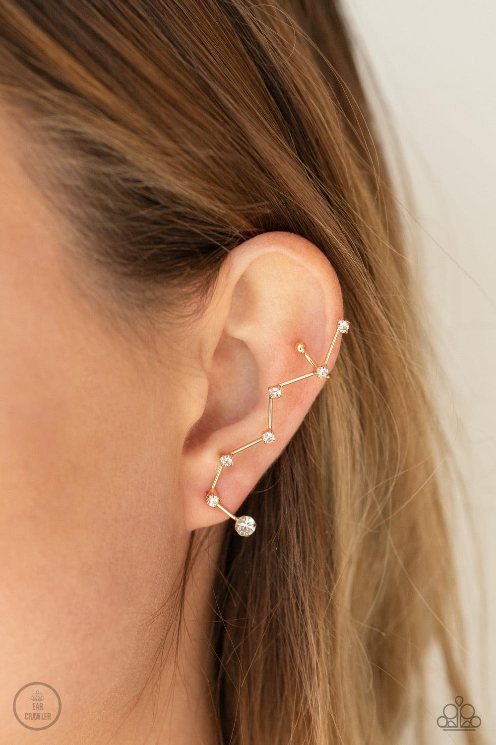 Paparazzi Accessories CONSTELLATION Prize - Gold Dotted with dainty white rhinestones, zigzagging gold bars delicately climb the ear, creating a sparkly constellation. Earring attaches to a standard post fitting. Features a dainty cuff attached to the top