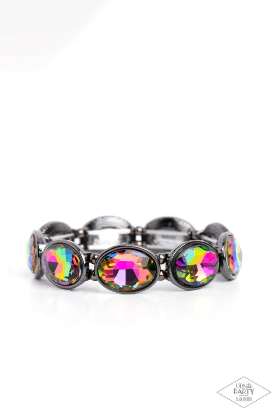 Paparazzi Accessories Diva In Disguise - Multi Glittery oil spill gems are pressed into sleek gunmetal frames. Infused with dainty gunmetal beads, the sparkly frames are threaded along stretchy bands for a glamorous look around the wrist. Sold as one indi