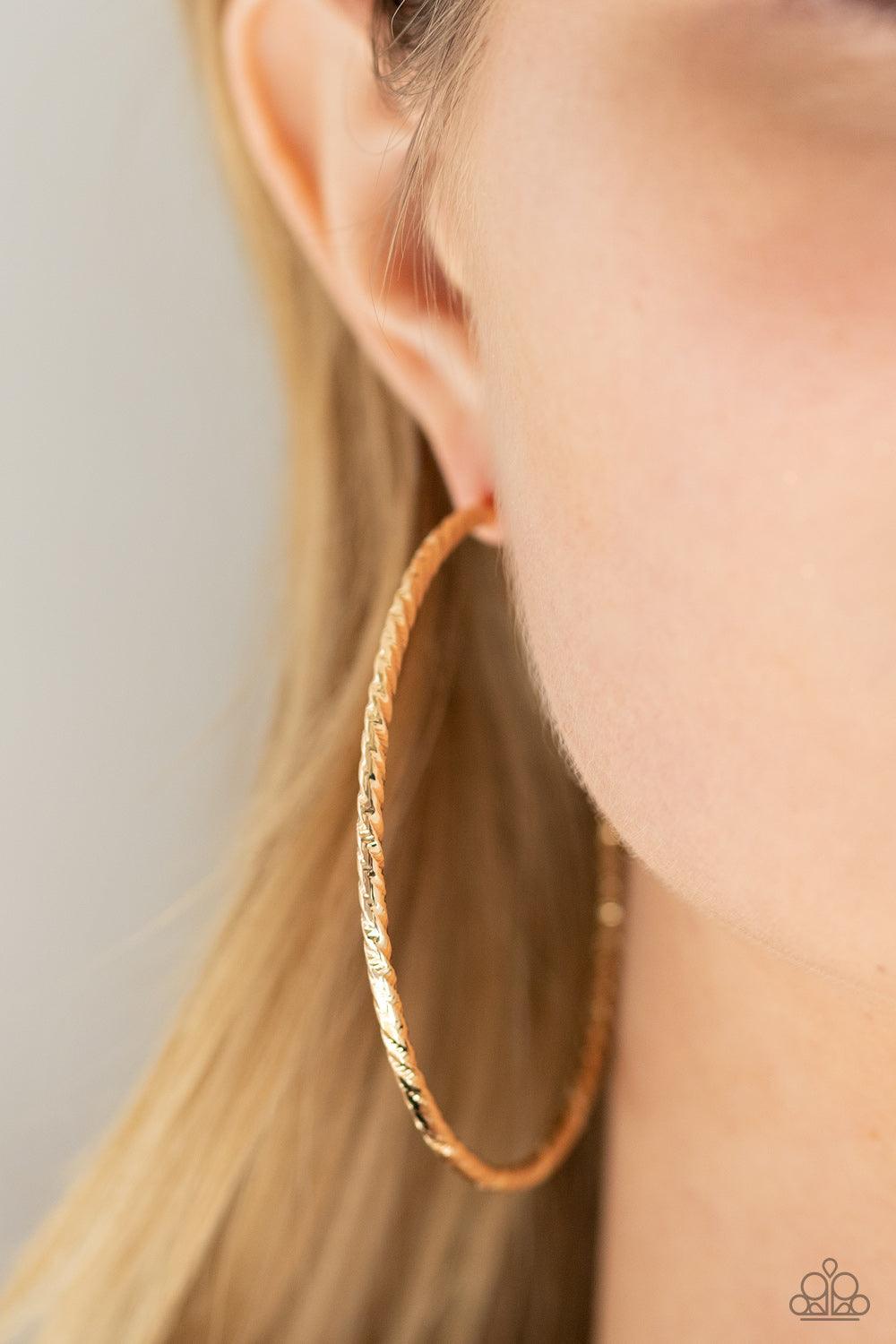 Paparazzi Accessories Voluptuous Volume - Gold Etched in twisted diamond-cut texture, an oversized gold bar delicately curls into a dramatically oversized hoop. Earring attaches to a standard post fitting. Hoop measures approximately 2 1/2" in diameter. S