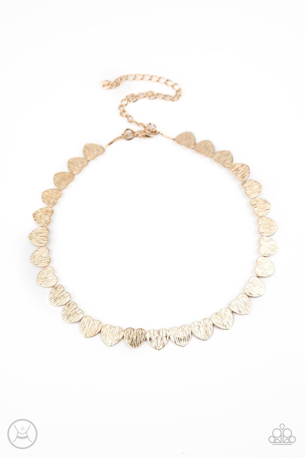 Paparazzi Accessories Playing HEART To Get - Gold Featuring a shimmery scratch finish, a dainty collection of shiny gold heart frames delicately connect around the neck for a flirtatious look. Feature an adjustable clasp closure. Sold as one individual ch