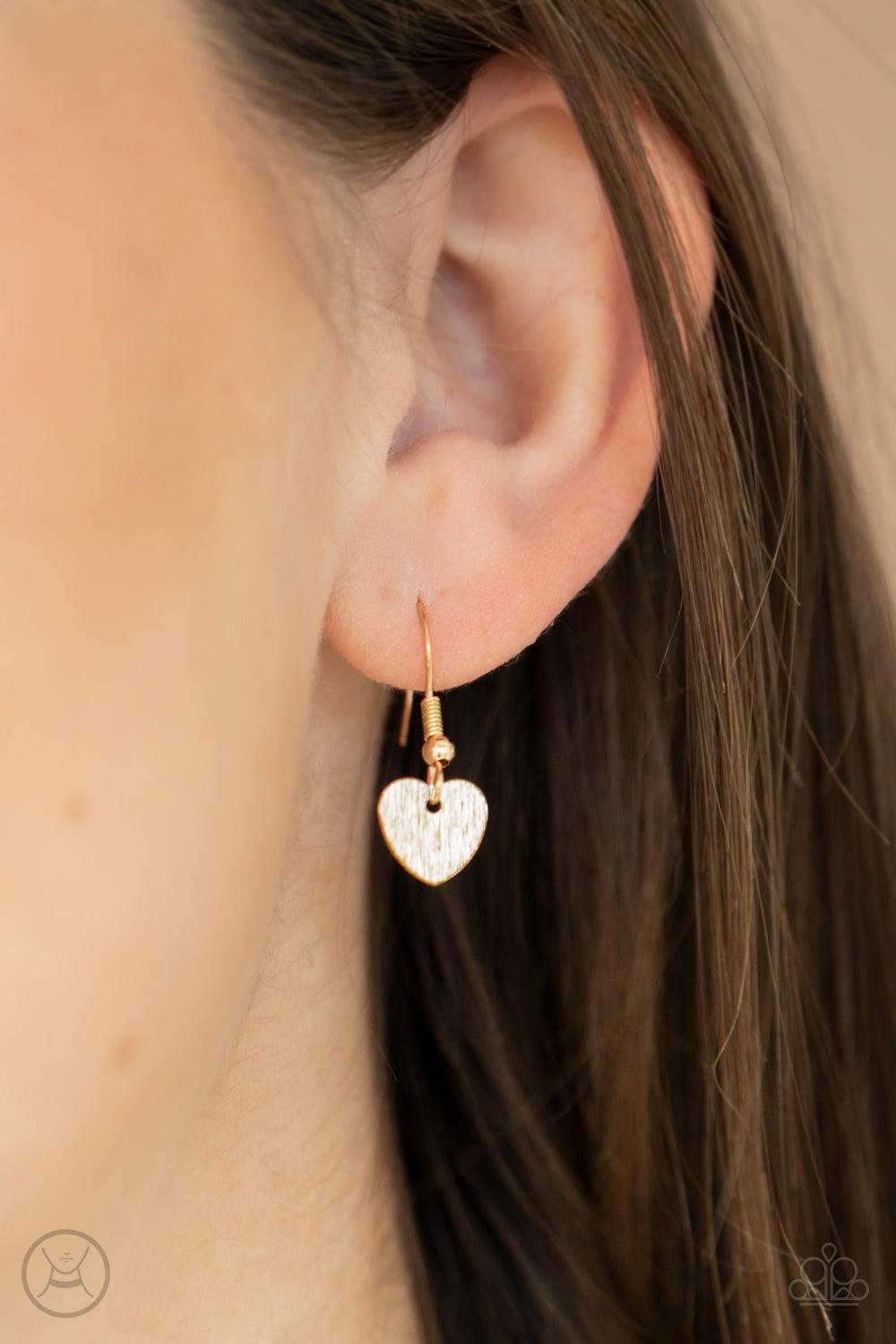 Paparazzi Accessories Playing HEART To Get - Gold Featuring a shimmery scratch finish, a dainty collection of shiny gold heart frames delicately connect around the neck for a flirtatious look. Feature an adjustable clasp closure. Sold as one individual ch