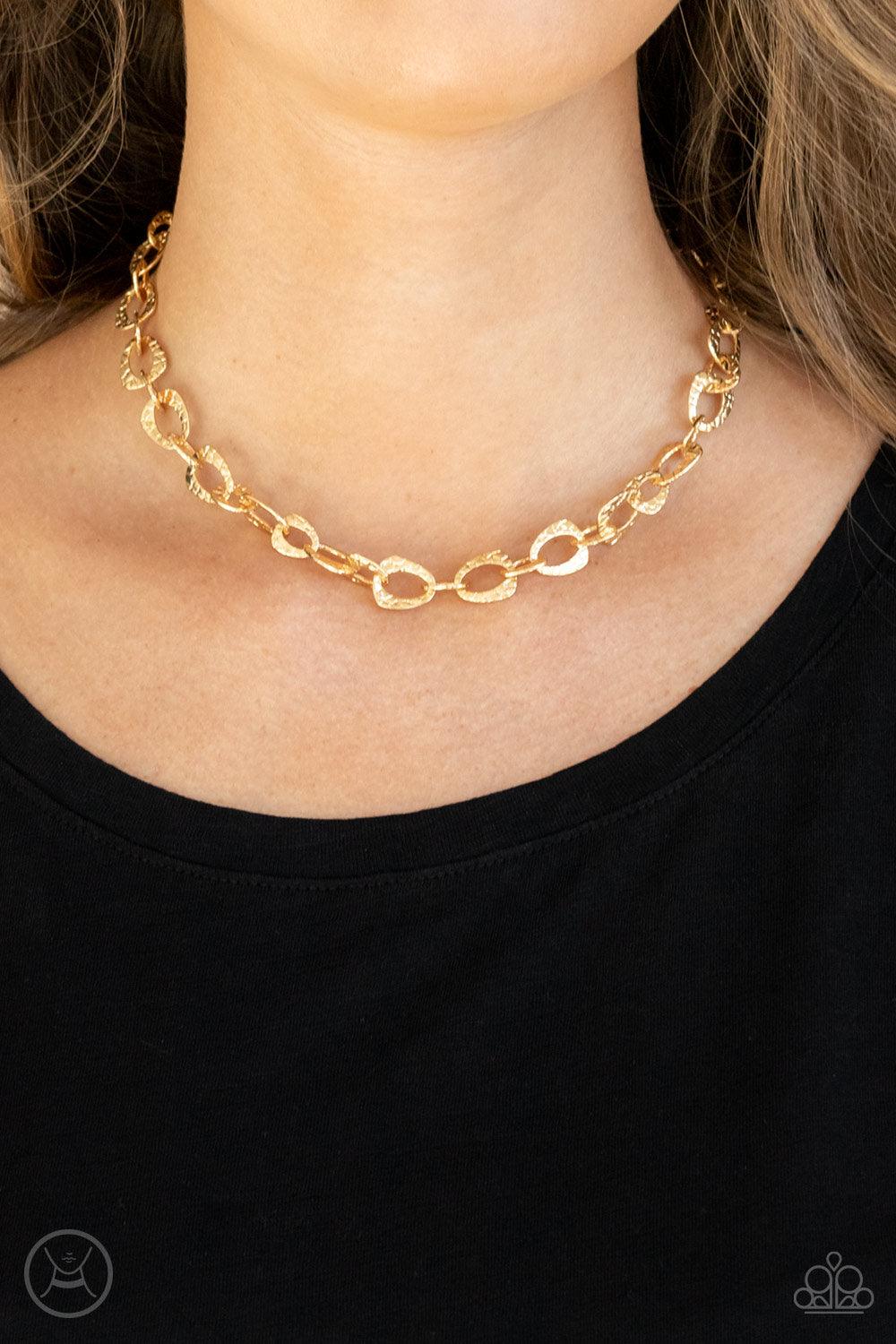 Paparazzi Accessories Urban Safari - Gold Embossed in a metallic crocodile-like print, asymmetrical gold links delicately connect around the neck for a wild industrial inspired look. Features an adjustable clasp closure. Sold as one individual choker neck