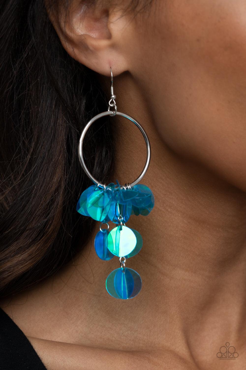 Paparazzi Accessories Holographic Hype - Blue Delicately folded in half, tassels of creased iridescent blue sequins swing from the bottom of a shiny silver hoop, creating an effervescent fringe. Earring attaches to a standard fishhook fitting. Sold as one