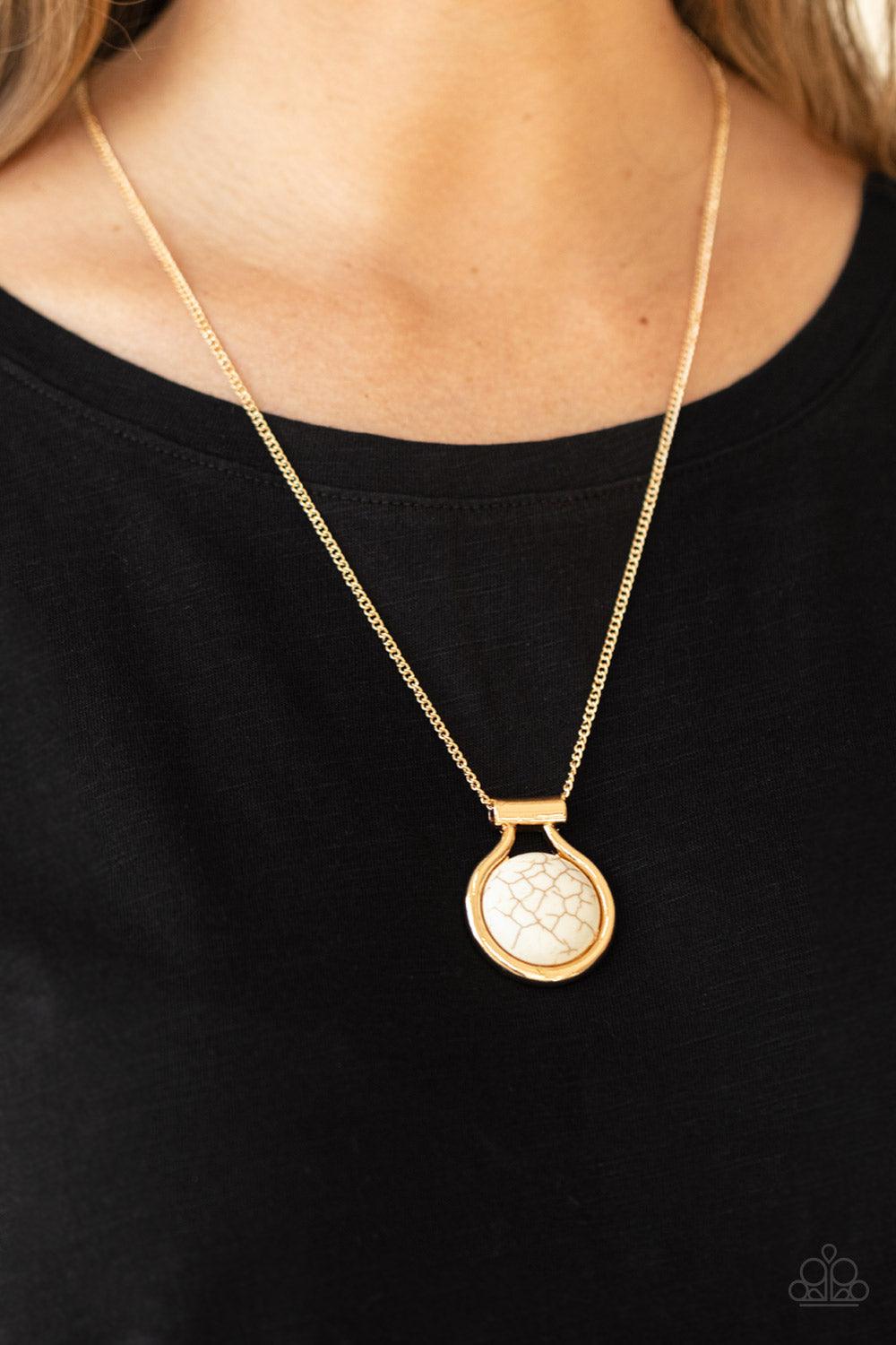 Paparazzi Accessories Patagonian Paradise - Gold Encased in an artisan inspired gold fitting, a refreshing white stone pendant glides along a gold chain for a colorfully seasonal look. Features an adjustable clasp closure. Sold as one individual necklace.