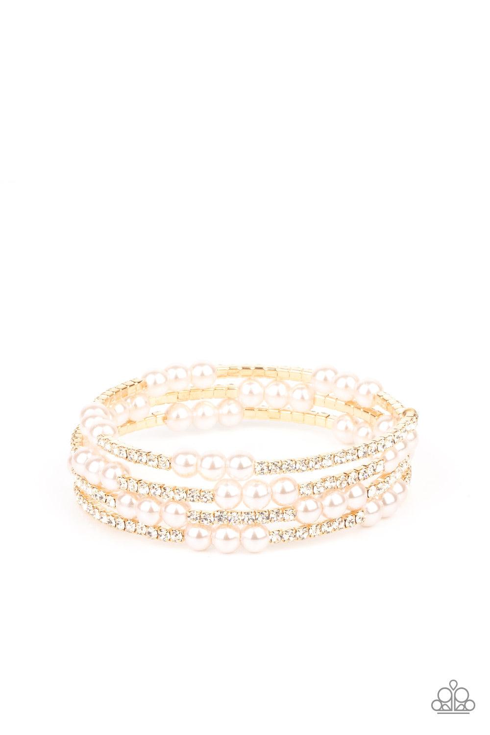 Paparazzi Accessories Hollywood Hospitality - Gold Sparkly sections of glassy white rhinestones and classic pearls are delicately threaded along a coiled wire, creating a glamorously golden infinity wrap style around the wrist. Sold as one individual brac