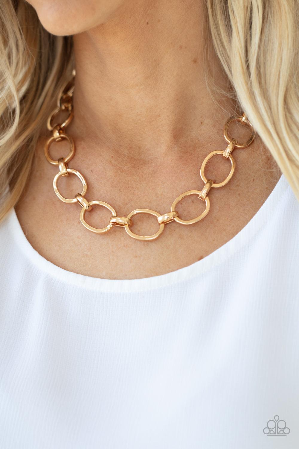 Paparazzi Accessories HAUTE-ly Contested - Gold A glistening series of dramatically oversized ovals and links boldly connect below the collar, creating an intense industrial statement. Features an adjustable clasp closure. Sold as one individual necklace.