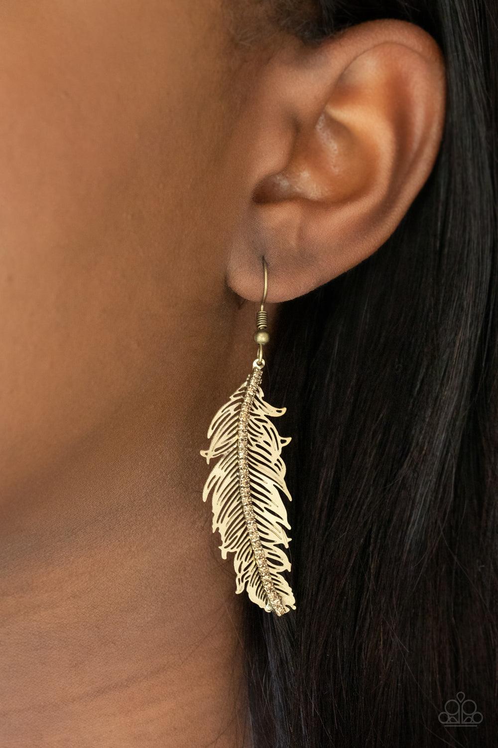 Paparazzi Accessories Fearless Flock - Brass A row of dainty golden topaz rhinestones are encrusted down the spine of a lifelike brass feather, creating a refined frame. Earring attaches to a standard fishhook fitting. Sold as one pair of earrings. Jewelr