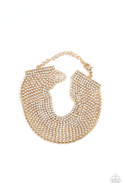 Paparazzi Accessories I Woke Up Like This - Gold Strung between two gold fittings, sparkly strand after sparkly strand of glittery white rhinestones layer around the wrist, creating a glamorous statement piece. Features an adjustable clasp closure. Sold a