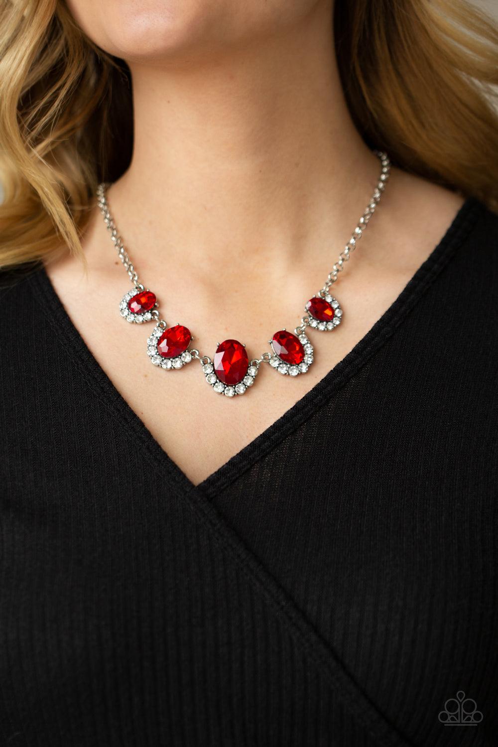 Paparazzi Accessories The Queen Demands It - Red Gradually increasing in size at the center, the sparkly bottoms of oversized red gems are bordered in rows of glassy white rhinestones as they link below the collar for a dramatic effect. Features an adjust