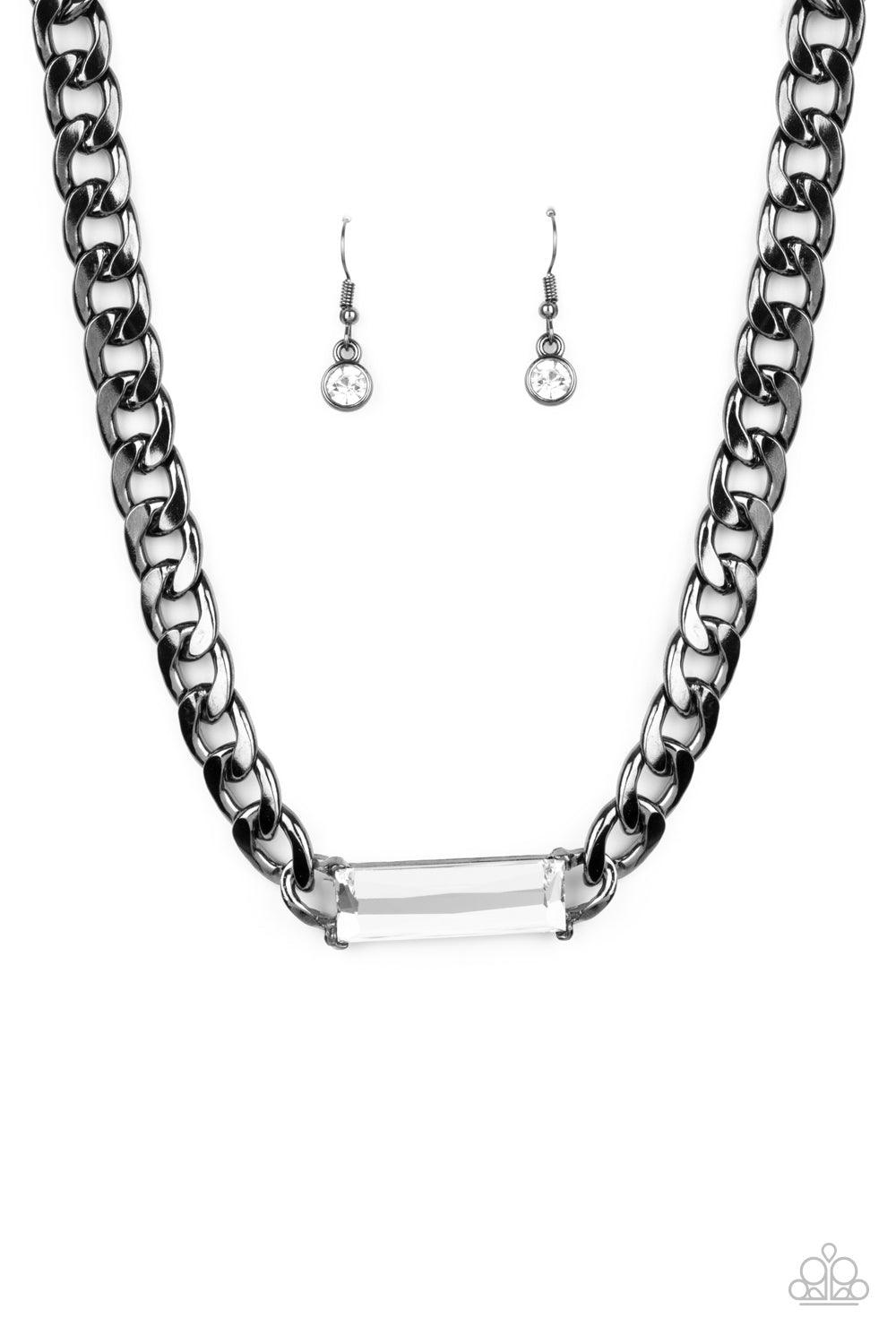 Paparazzi Accessories Urban Royalty - Black A dramatically oversized row of gunmetal chain attaches to a white emerald cut rhinestone pendant, creating a demanding centerpiece below the collar. Features an adjustable clasp closure. Sold as one individual