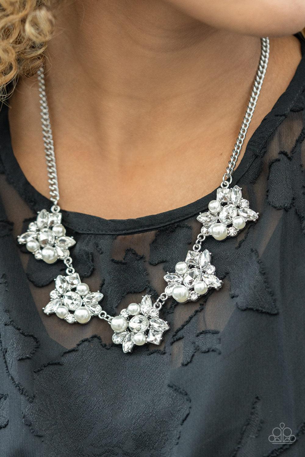 Paparazzi Accessories HEIRESS of Them All - White Bubbly white pearls and regally cut white rhinestones coalesce into blinding frames that glamorously link below the collar, creating a timeless fringe. Features an adjustable clasp closure. Sold as one ind