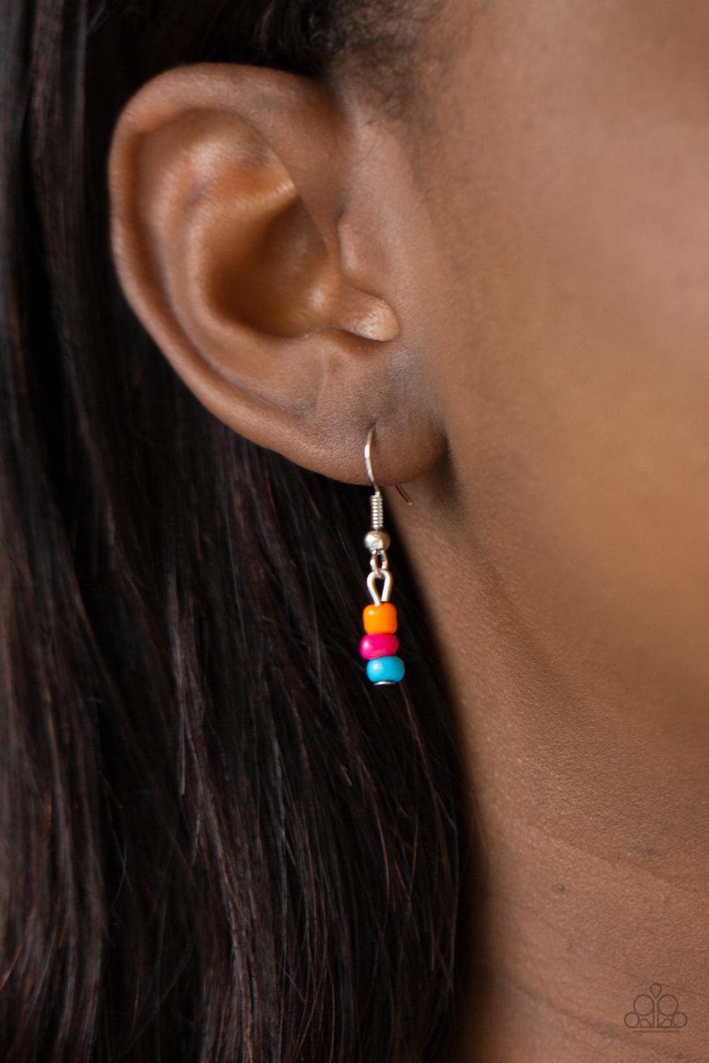 Paparazzi Accessories Summery Sensations - Multi Dainty orange, blue, and pink wooden beads are sporadically threaded along earthy strands of knotted twine-like layers draped across the chest. Matching beaded strands stream out from the bottom of a decora