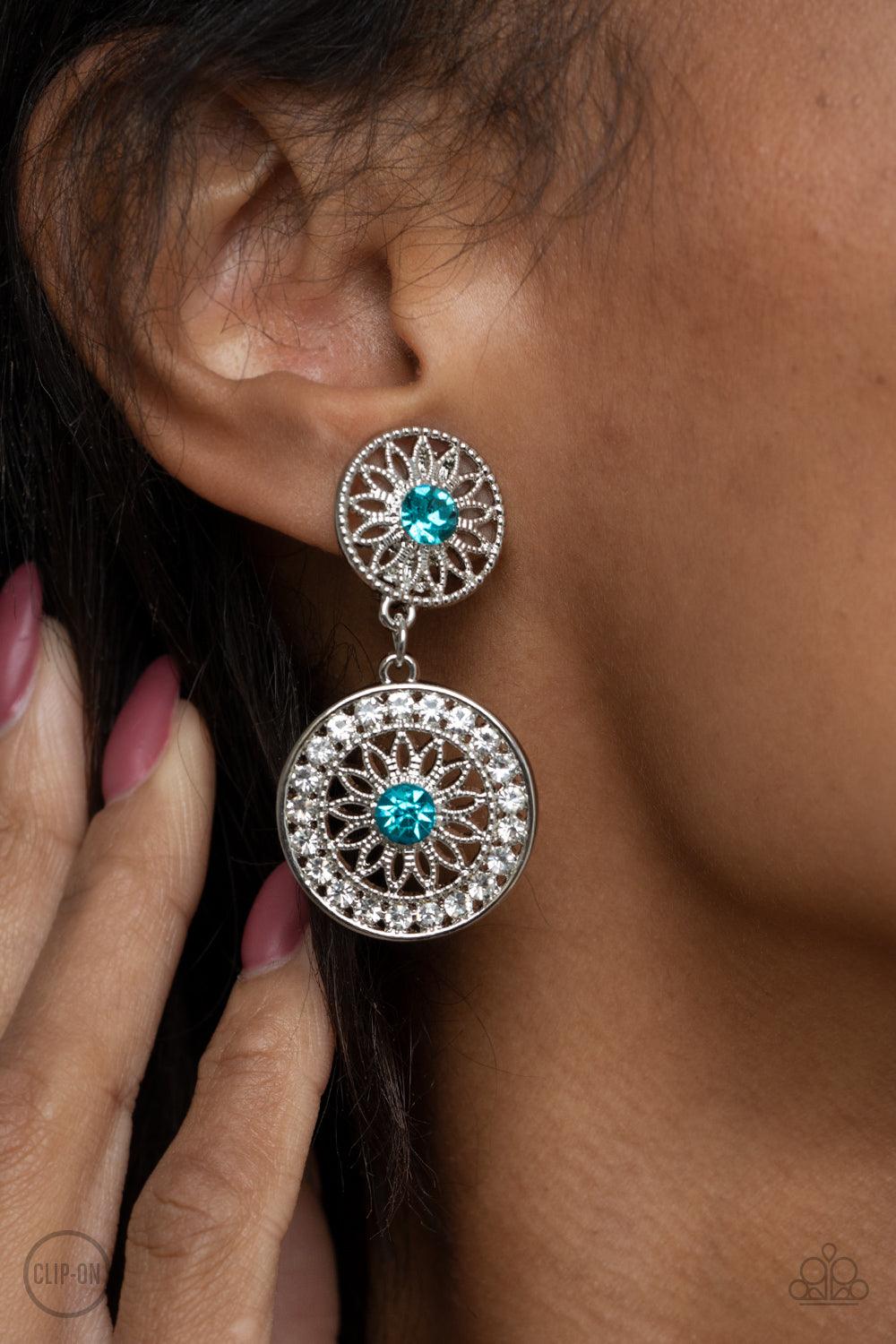 Paparazzi Accessories Life of The Garden Party - Blue *Clip-On Dotted with glittery blue rhinestone centers, shimmery silver floral frames link into a whimsical lure. The lower frame is bordered in glassy white rhinestones for a timeless finish. Earring a