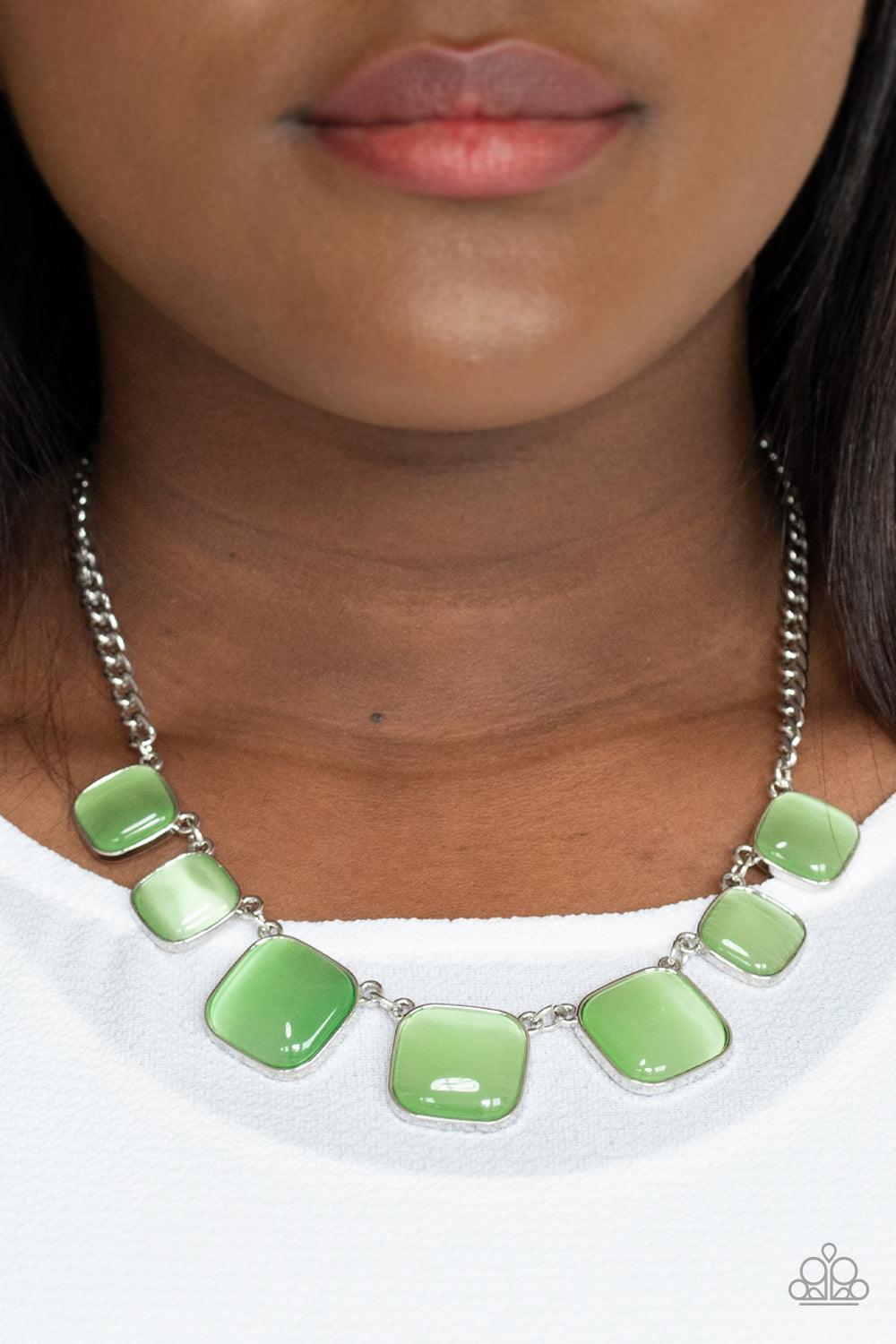 Paparazzi Accessories Aura Allure - Green Encased in square silver fittings, a dewy collection of green cat's eye stones gradually increase in size as they link below the collar for a whimsical pop of color. Features an adjustable clasp closure. Sold as o