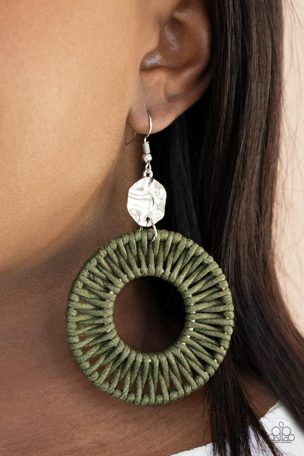 Paparazzi Accessories Total Basket Case - Green Green twine-like cording weaves around two silver rings, creating a woven hoop at the bottom of a hammered silver disc. Earring attaches to a standard fishhook fitting. Sold as one pair of earrings. Jewelry