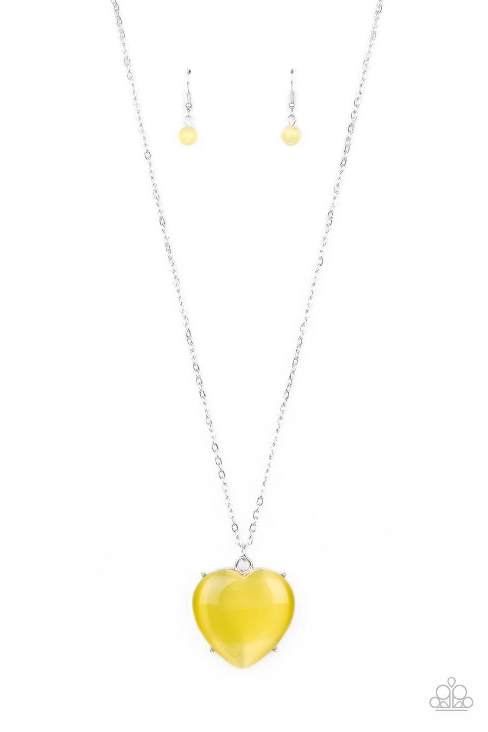Paparazzi Accessories Warmhearted Glow - Yellow An oversized Illuminating cat's eye stone frame swings from the bottom of a lengthened silver chain, creating a flirtatious pendant. Features an adjustable clasp closure. Sold as one individual necklace. Inc