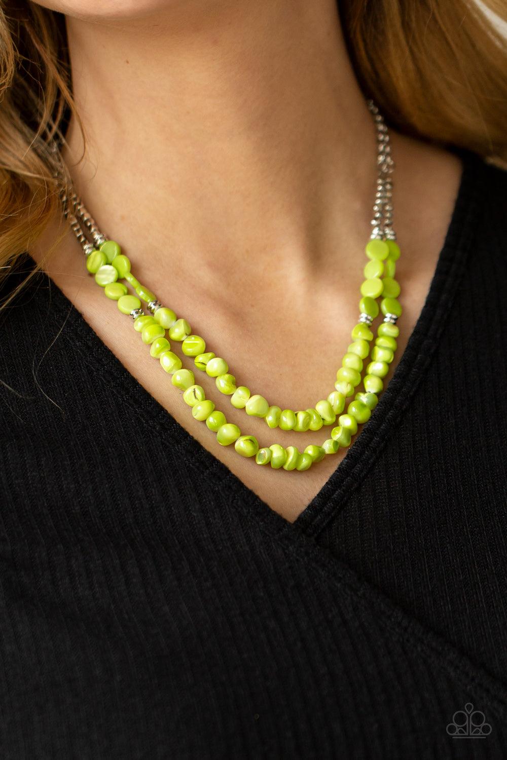 Paparazzi Accessories Staycation Status - Green Infused with dainty silver cube and round beaded accents, green shell-like beads are threaded along invisible wires below the collar for a summery inspiration. Features an adjustable clasp closure. Sold as o