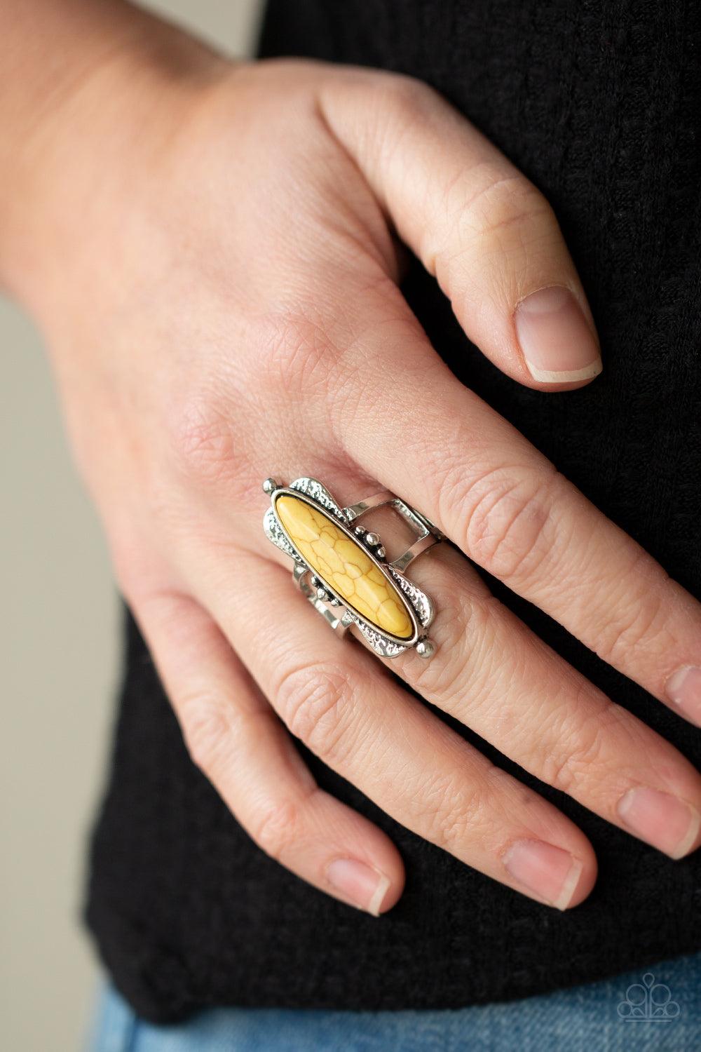 Paparazzi Accessories Cottage Craft - Yellow An oblong yellow stone is pressed into a flared silver frame featuring studded accents, creating an abstract centerpiece atop the finger. Features a stretchy band for a flexible fit. Sold as one individual ring