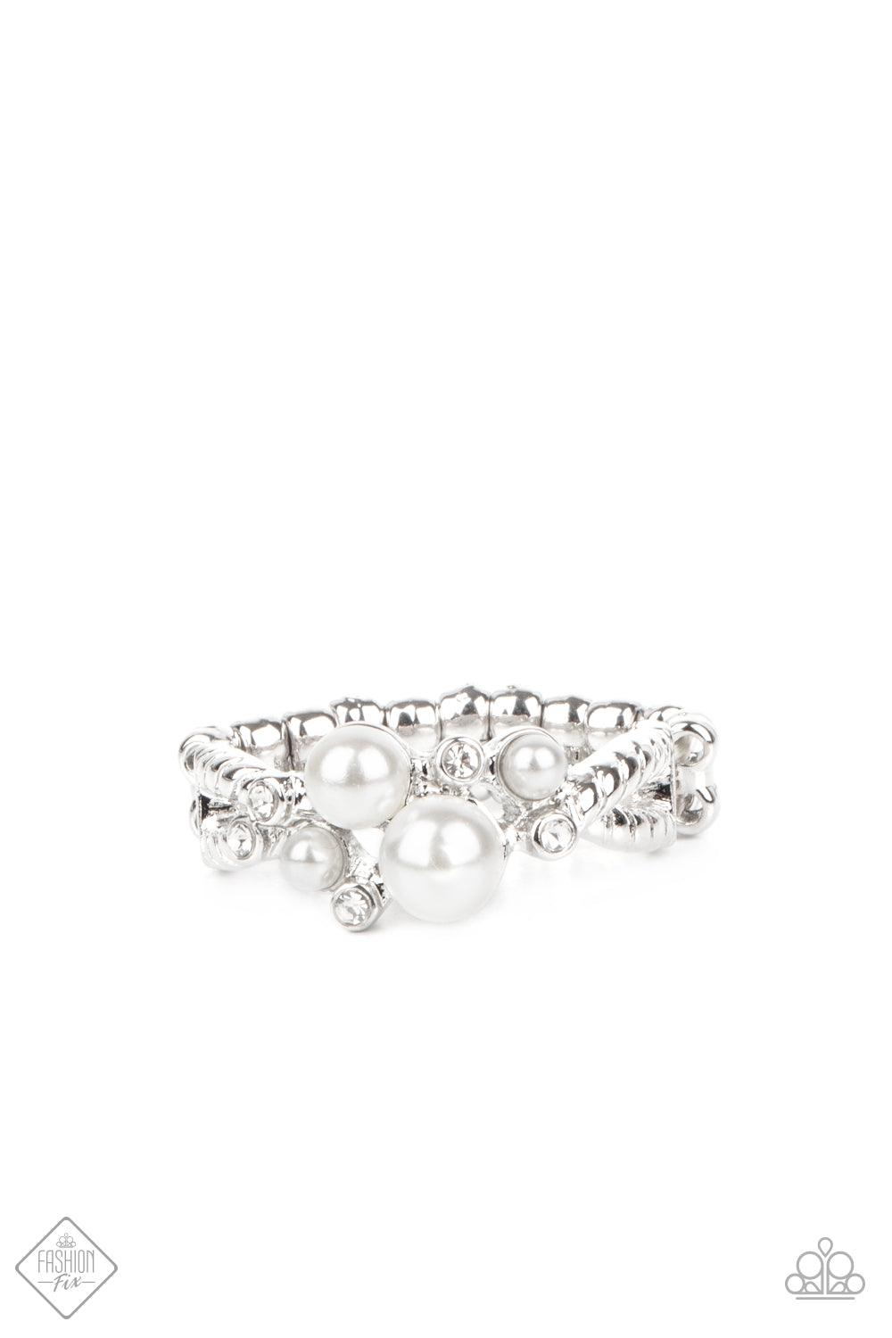 Paparazzi Accessories Avant-Vintage - White A bubbly pearl and sparkly white rhinestone centerpiece sits atop a pair of textured silver bars that delicately crisscross across the finger, creating an dainty display. Features a dainty stretchy band for a fl