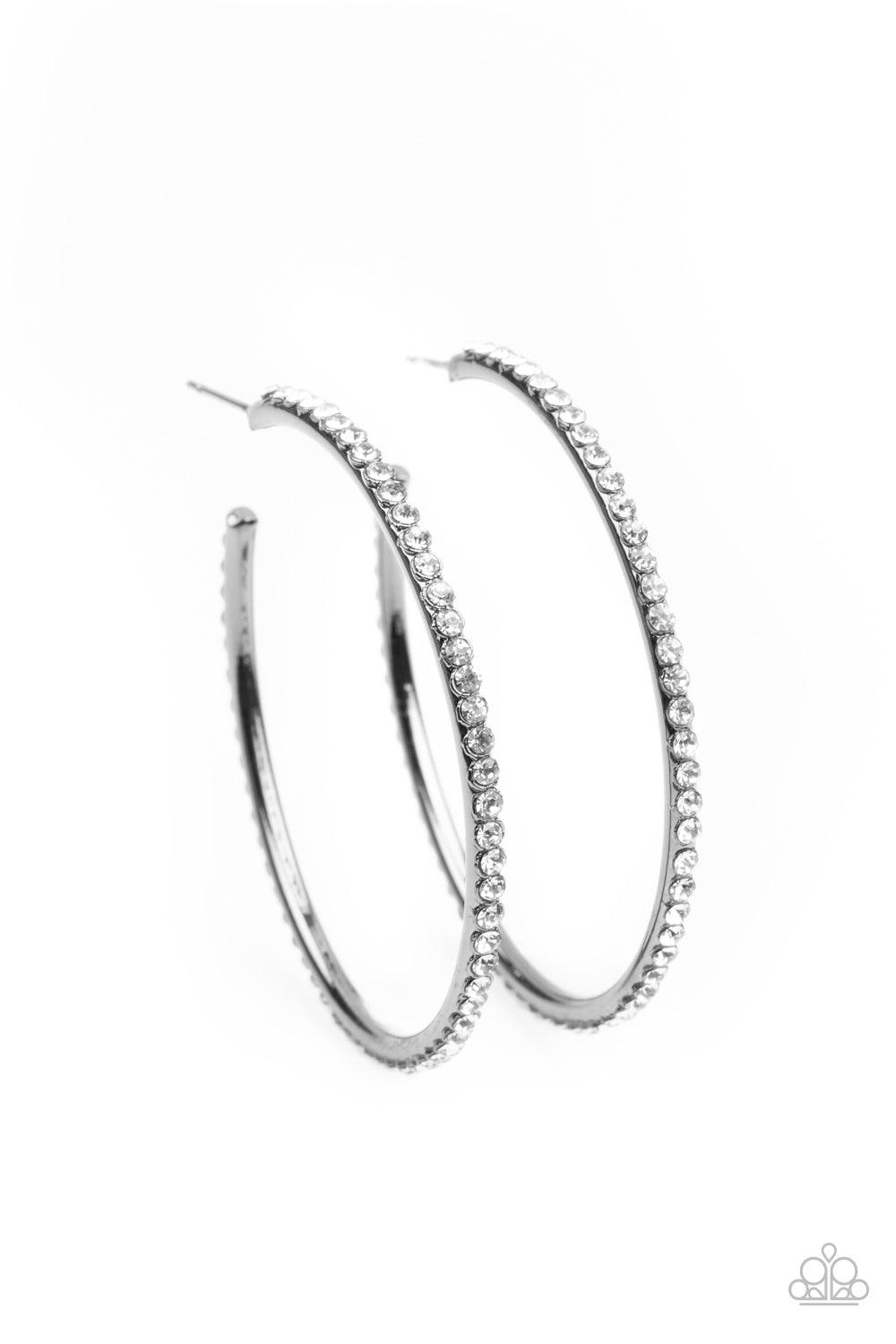 Paparazzi Accessories By Popular Vote - Black The spine of a gunmetal hoop is encrusted in dainty white rhinestones, creating wraparound shimmer. Earring attaches to a standard post fitting. Hoop measures approximately 1 3/4" in diameter. Sold as one pair
