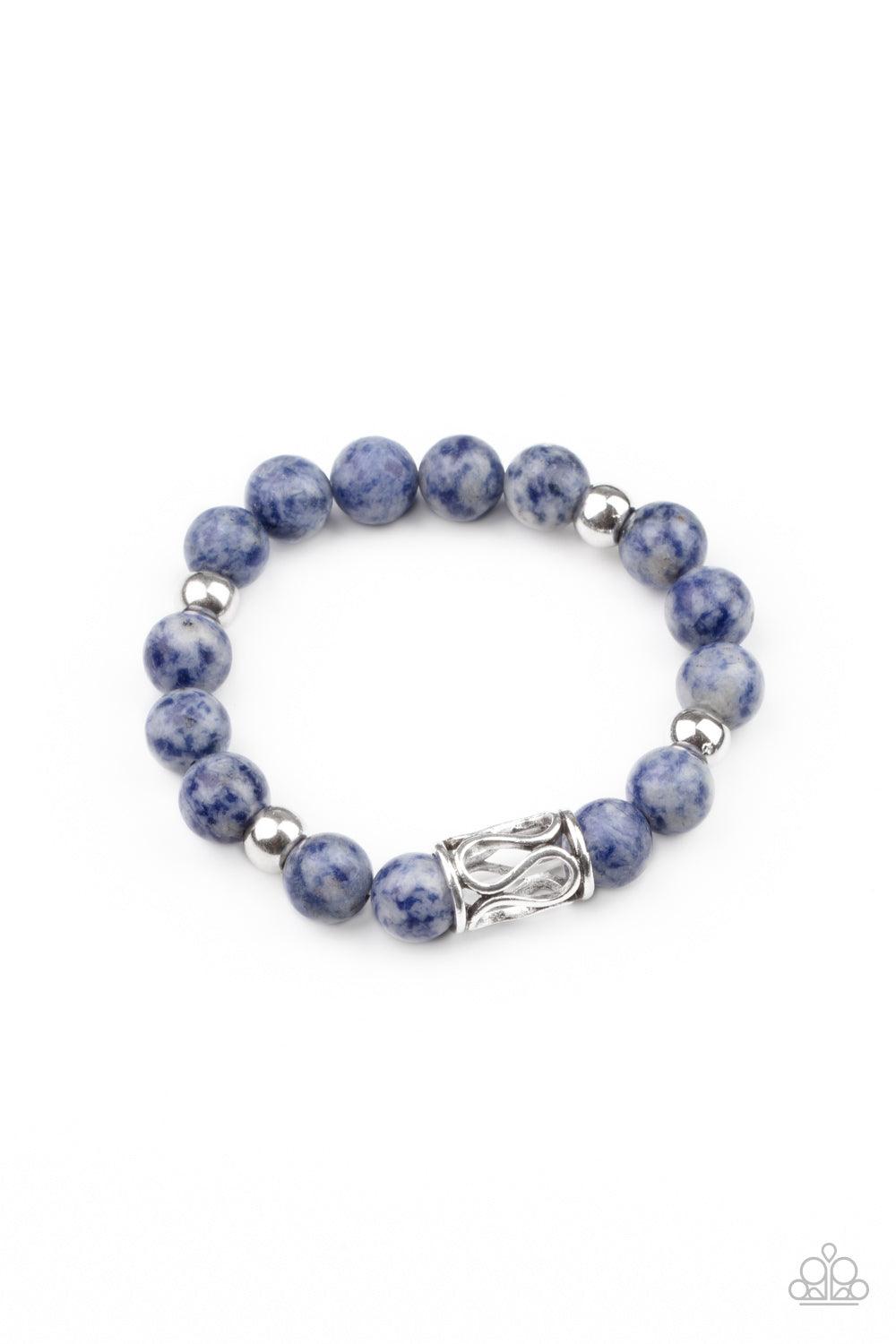 Paparazzi Accessories Soothes The Soul - Blue Infused with an ornate silver centerpiece, an earthy collection of silver and lapis lazuli beads are threaded along a stretchy band around the wrist for a seasonal flair. Sold as one individual bracelet. Jewel