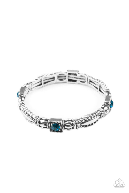 Paparazzi Accessories Get This GLOW On The Road - Blue Dotted with blue rhinestone centers, decorative silver frames are threaded along stretchy bands around the wrist, creating a colorful display. Sold as one individual bracelet. Jewelry