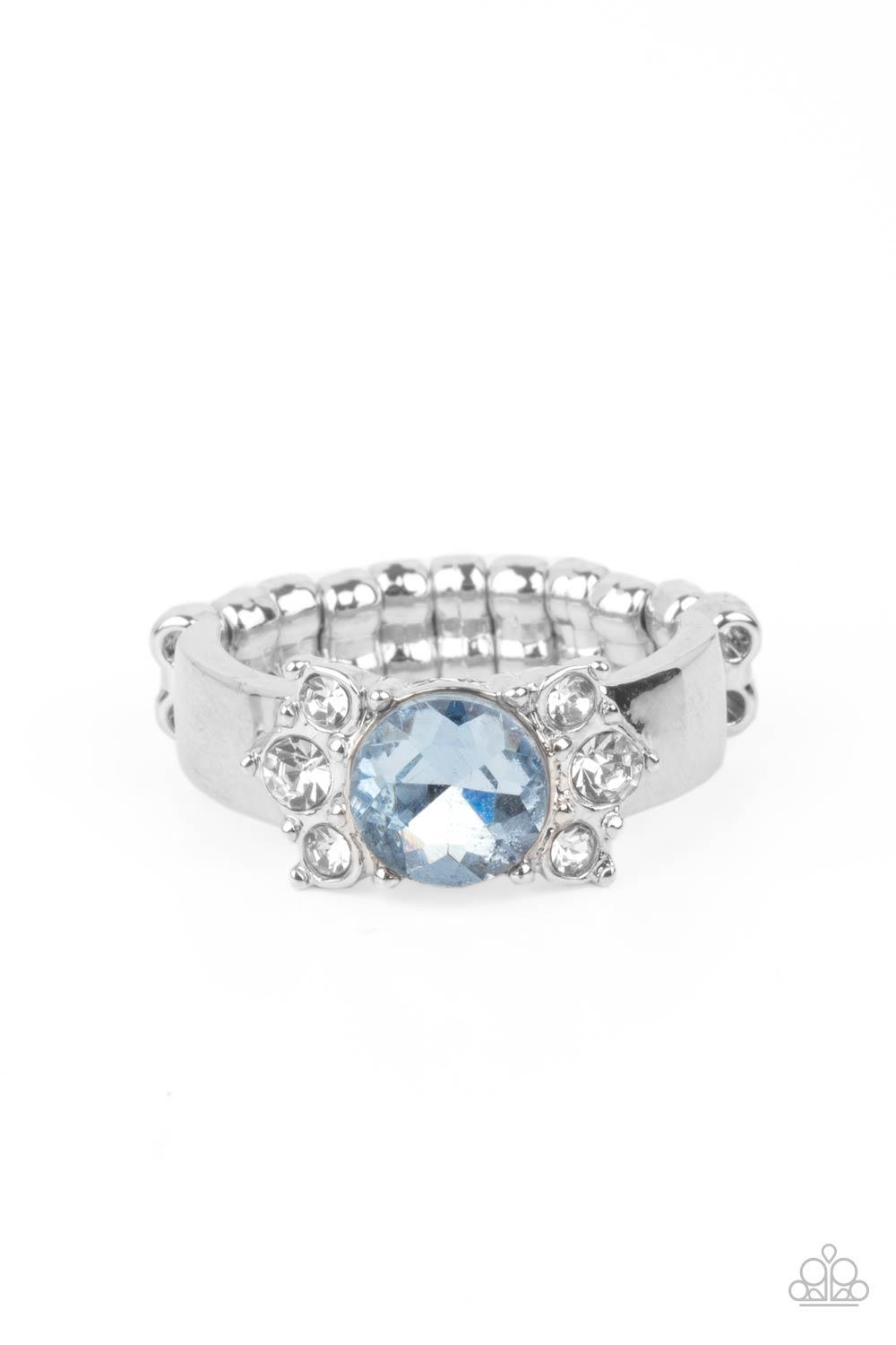 Paparazzi Accessories ROYAL Till The End - Blue Trios of glassy white rhinestones flank an oversized Cerulean rhinestone, creating a sparkly centerpiece atop a dainty silver band. Features a dainty stretchy band for a flexible fit. Sold as one individual