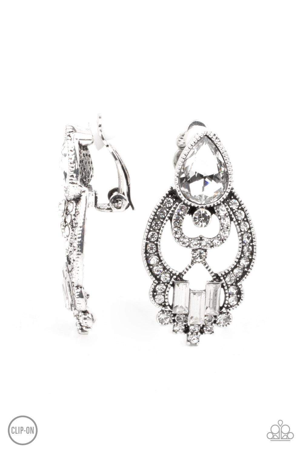 Paparazzi Accessories Glamour Gauntlet - White *Clip-On An oversized white teardrop gem and dainty row of white emerald cut rhinestones adorn a regal white rhinestone encrusted frame, creating a royal statement piece. Earring attaches to a standard clip-o