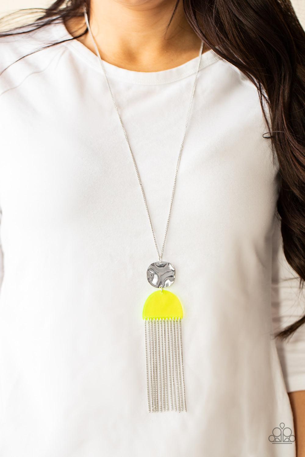 Paparazzi Accessories Color Me Neon - Yellow A hammered silver disc connects to a neon yellow half moon acrylic frame at the bottom of a lengthened silver chain. A curtain of shimmery chains stream from the bottom of the stacked pendant, adding flirtatiou