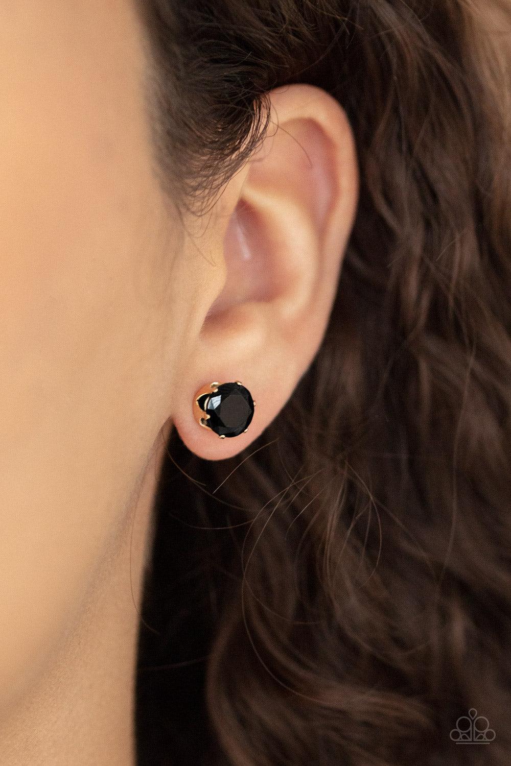 Paparazzi Accessories Modest Motivation - Gold An oversized black rhinestone is nestled inside a pronged gold fitting, creating a timeless statement piece. Earring attaches to a standard post fitting. Sold as one pair of post earrings. Jewelry