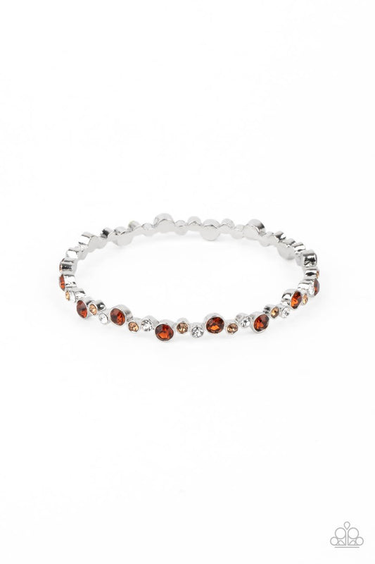 Paparazzi Accessories Twinkly Trendsetter - Brown Encased in sleek silver fittings, a twinkly collection of topaz, golden topaz, and white rhinestones coalesce into a glittery bangle around the wrist. Sold as one individual bracelet. Jewelry