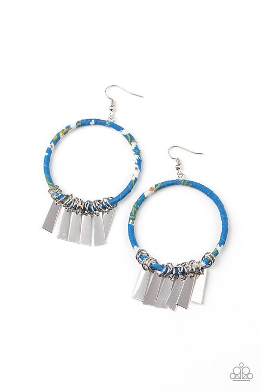 Paparazzi Accessories Garden Chimes - Blue Flared rectangular silver plates swing from the bottom of a hoop wrapped in blue, black, green, and white floral fabric, creating a whimsical fringe. Earring attaches to a standard fishhook fitting. Sold as one p