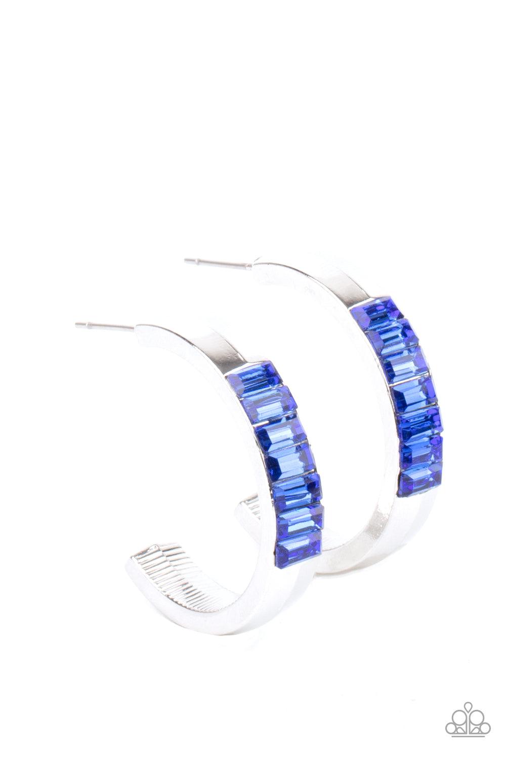 Paparazzi Accessories Bursting With Brilliance - Blue The front of a thick silver hoop is encrusted in glittery blue emerald cut rhinestones, creating a glamorous pop of color. Earring attaches to a standard post fitting. Hoop measures approximately 1" in
