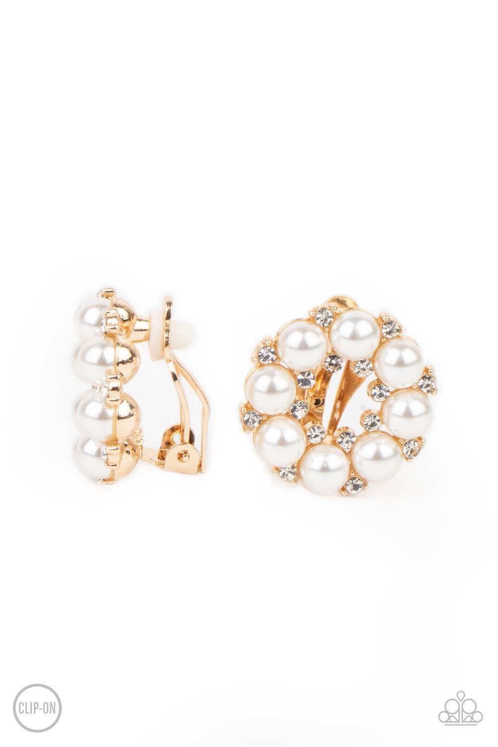 Paparazzi Accessories Roundabout Ritz - Gold *Clip-On A timeless collection of dainty white rhinestones and classic white rhinestones spin into a bubbly hoop. Earring attaches to a standard clip-on fitting. Sold as one pair of clip-on earrings. Jewelry