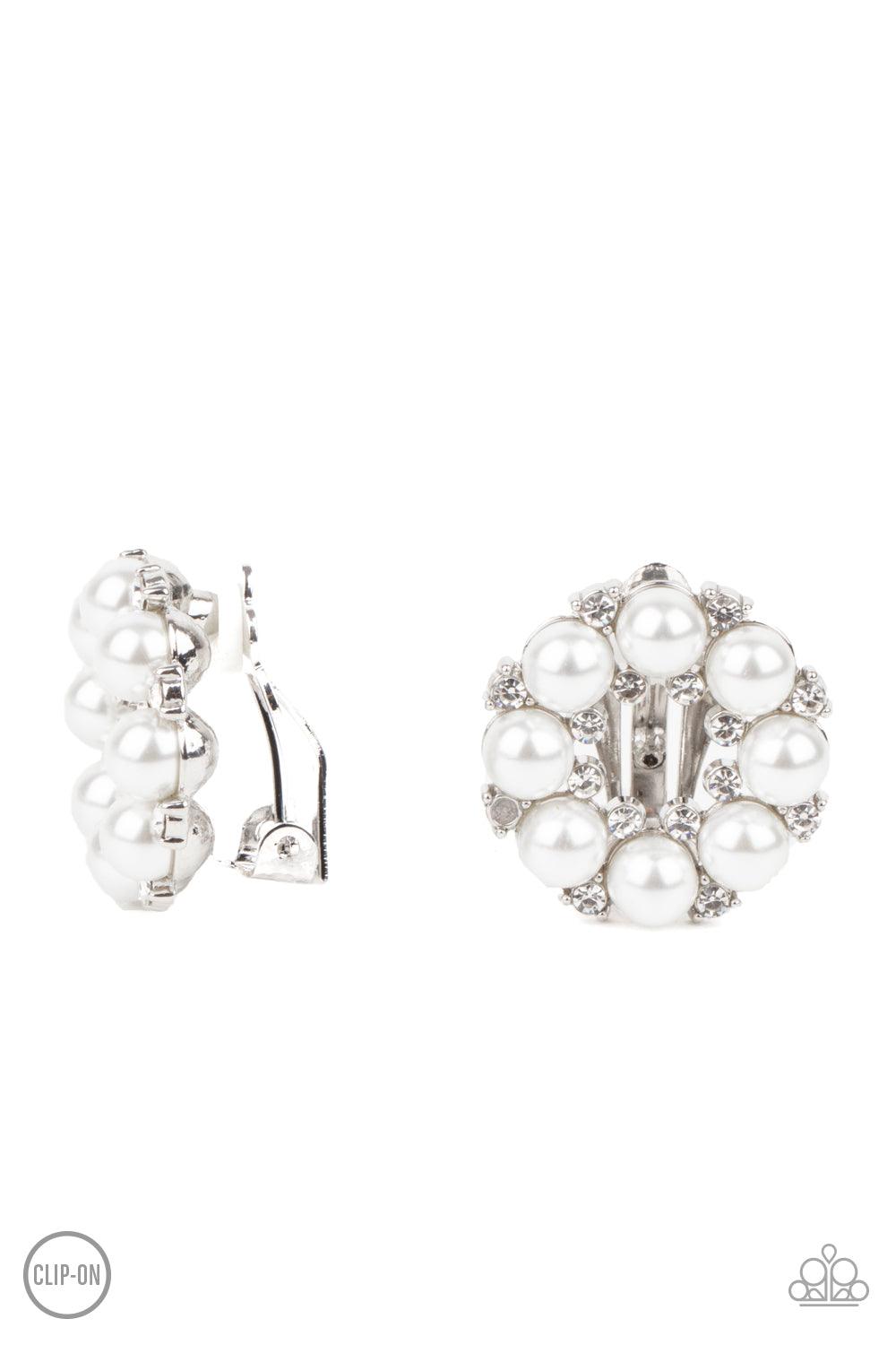 Paparazzi Accessories Roundabout Ritz - White *Clip-On A timeless collection of dainty white rhinestones and classic white rhinestones spin into a bubbly hoop. Earring attaches to a standard clip-on fitting. Sold as one pair of clip-on earrings. Jewelry