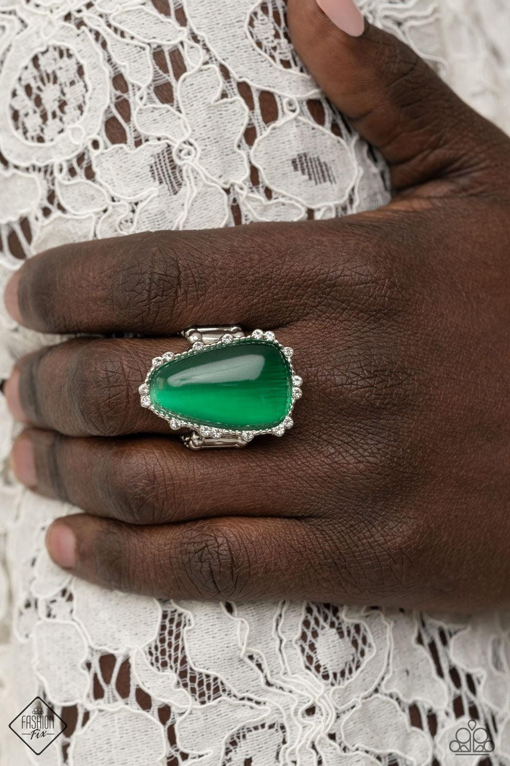 Paparazzi Accessories Newport Nouveau - Green A tranquil asymmetrical Mint cat’s eye stone teardrop is nestled inside a studded silver frame sporadically dotted in dainty white rhinestones, creating an elegantly enchanting centerpiece atop the finger. Fea