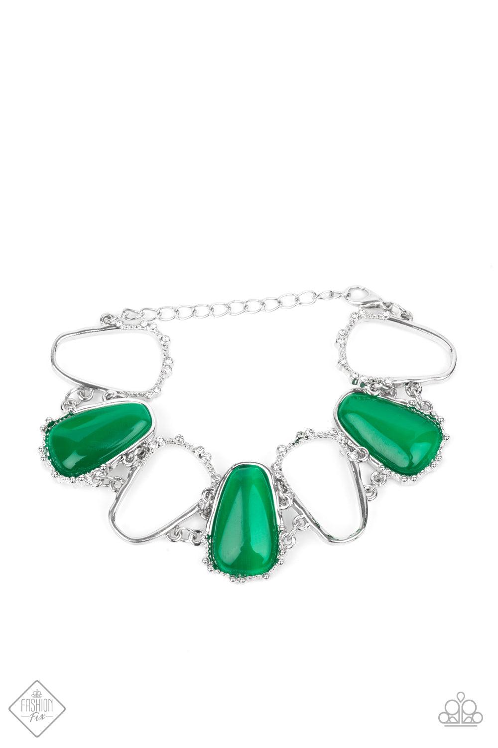 Paparazzi Accessories Yacht Club Couture - Green Encased in studded silver frames, a tranquil collection of asymmetrical Mint cat’s eye stone teardrops and airy silver frames delicately link around the wrist for an ethereally sparkly display. A sprinkling