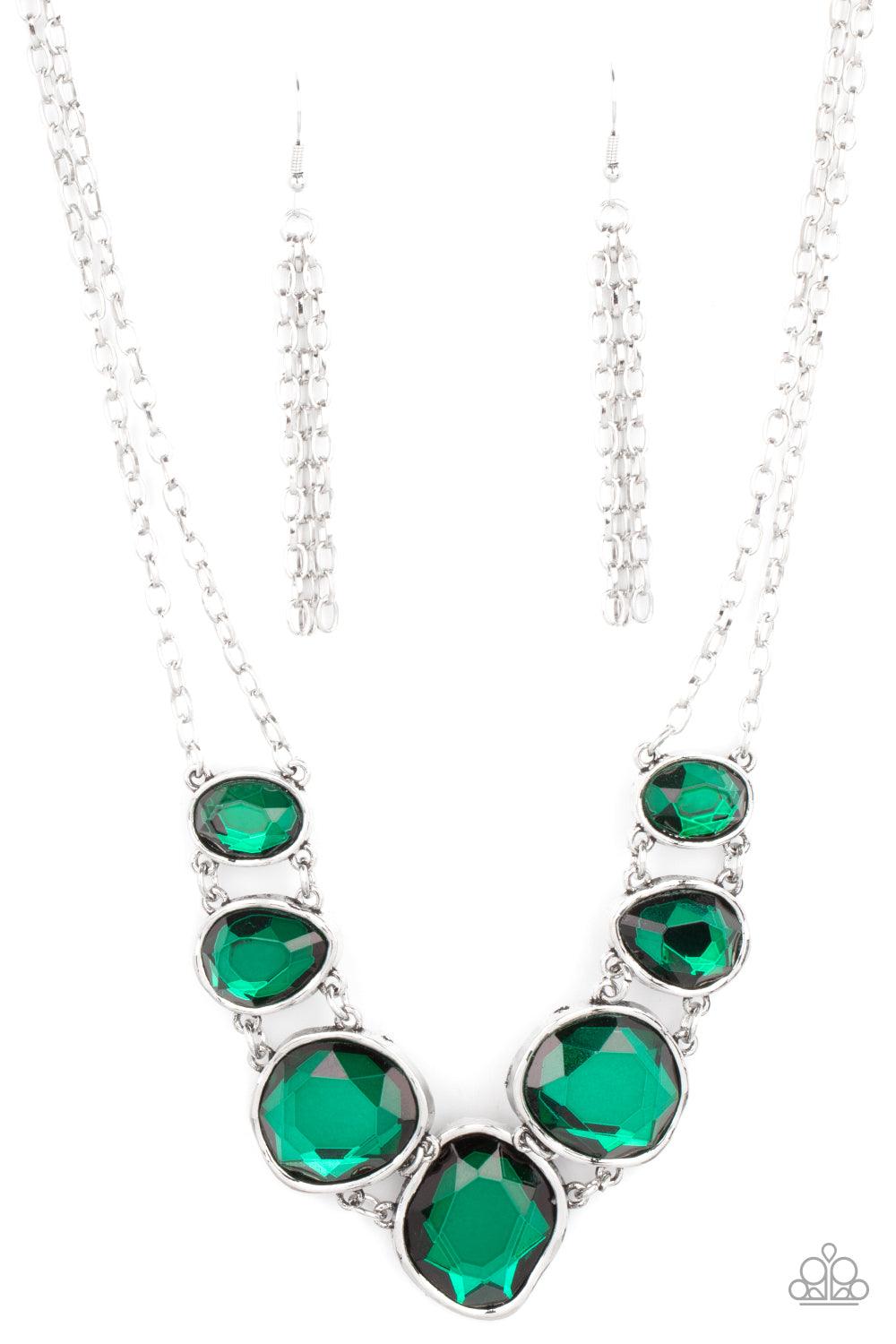 Paparazzi Accessories Absolute Admiration - Green Encased in hammered asymmetrical silver frames, an imperfect collection of faceted green gems are suspended from two shimmery silver chains as they double-link below the collar for a dramatic effect. Featu